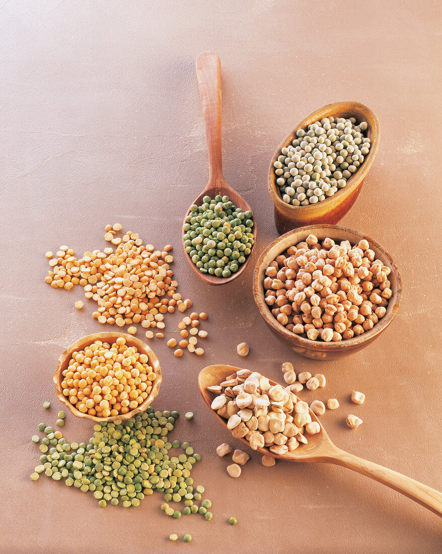 Different types of peas in bowl with spoon
