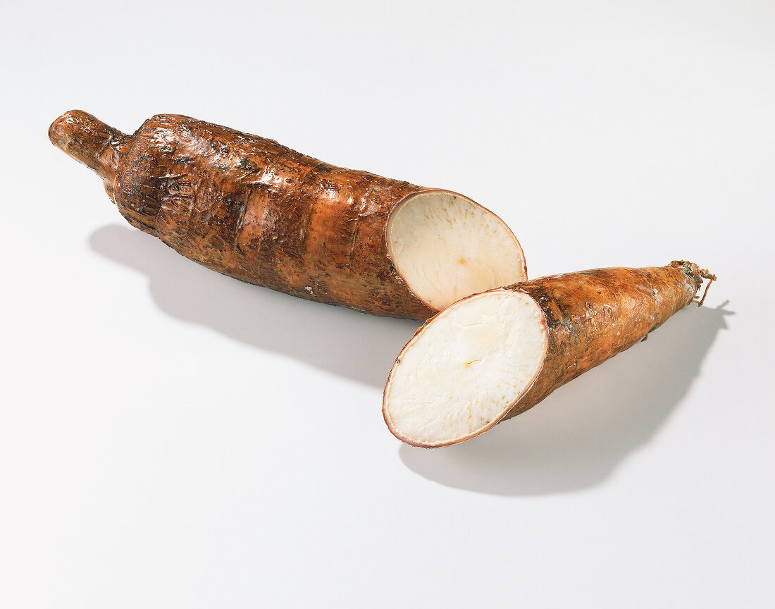 Halved cassava on white background