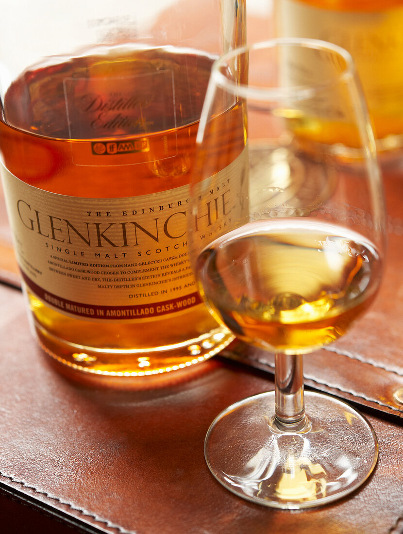 Close-up of whiskey glass and bottle