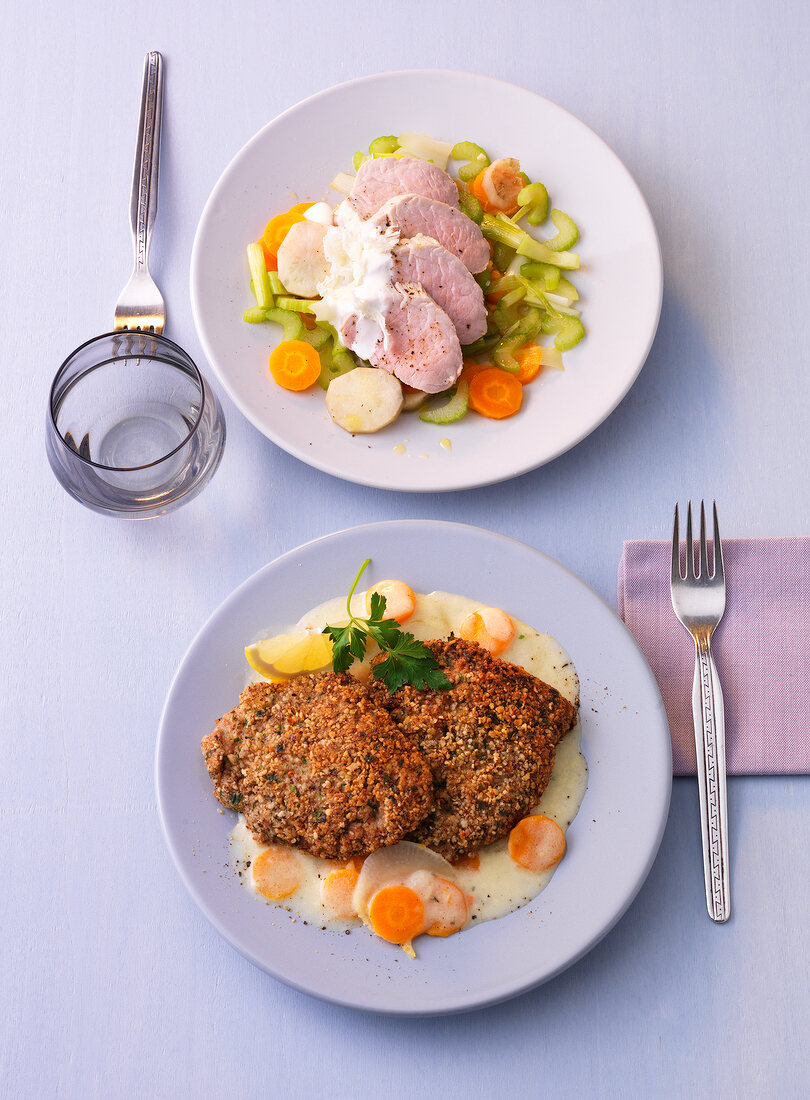 Fried veal cutlets with poached pork on plate