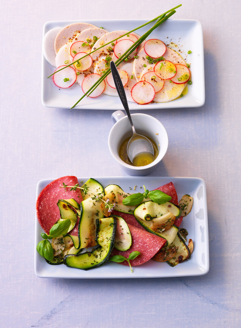 Marinated zucchini with radish, sausage and carpaccio on plate