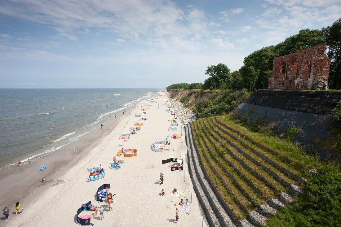 Tourists relaxing on beach of Trzesacz in Poland