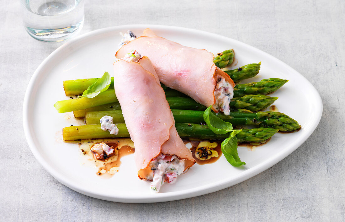 Turkey rolls filled with ricotta and green asparagus on plate