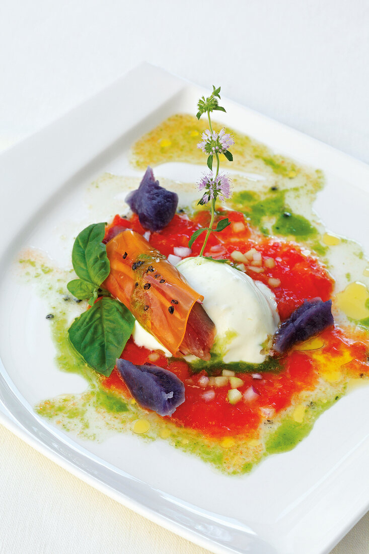 Sardines with tomato jelly cannelloni, gazpacho and goat cheese on plate