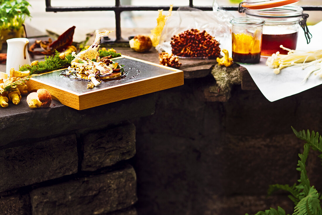 Autumn mushrooms and other food items on stone countertop