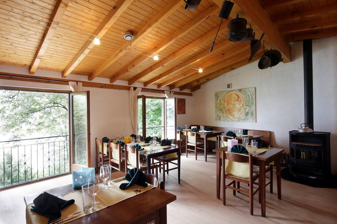 Tables laid in dining room of Grotto Sassalto Restaurant, Caslano, Switzerland