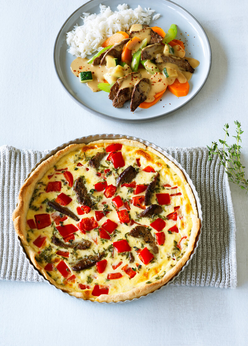 Spicy beef and pepper quiche in baking tin