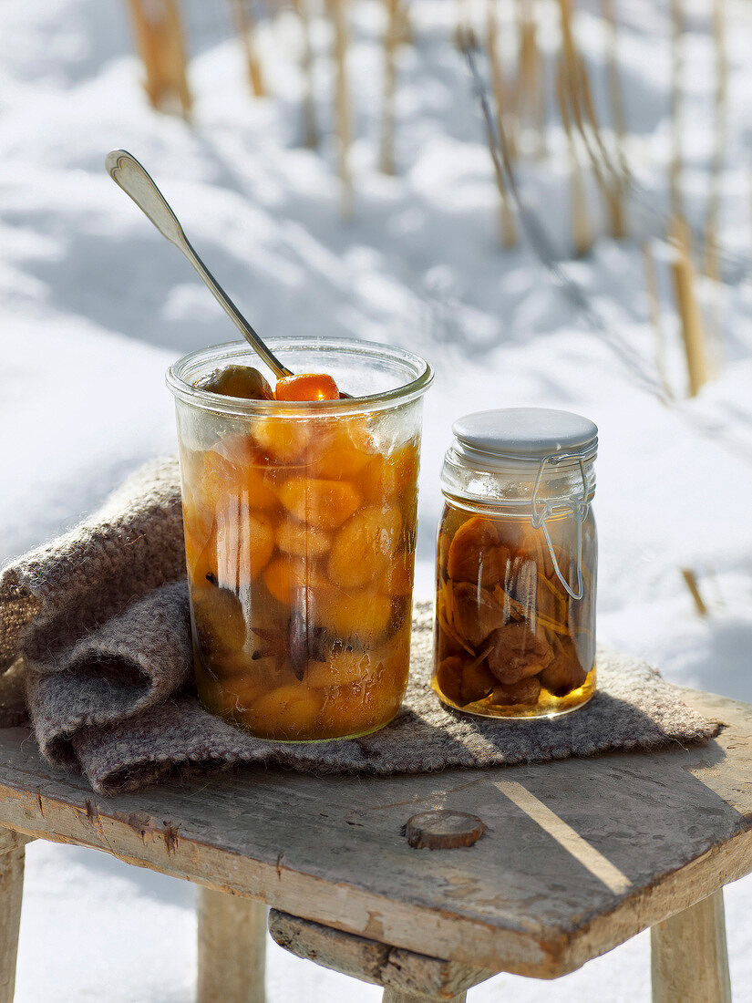 Pickled winter fruits and chestnuts in glass jar for winter