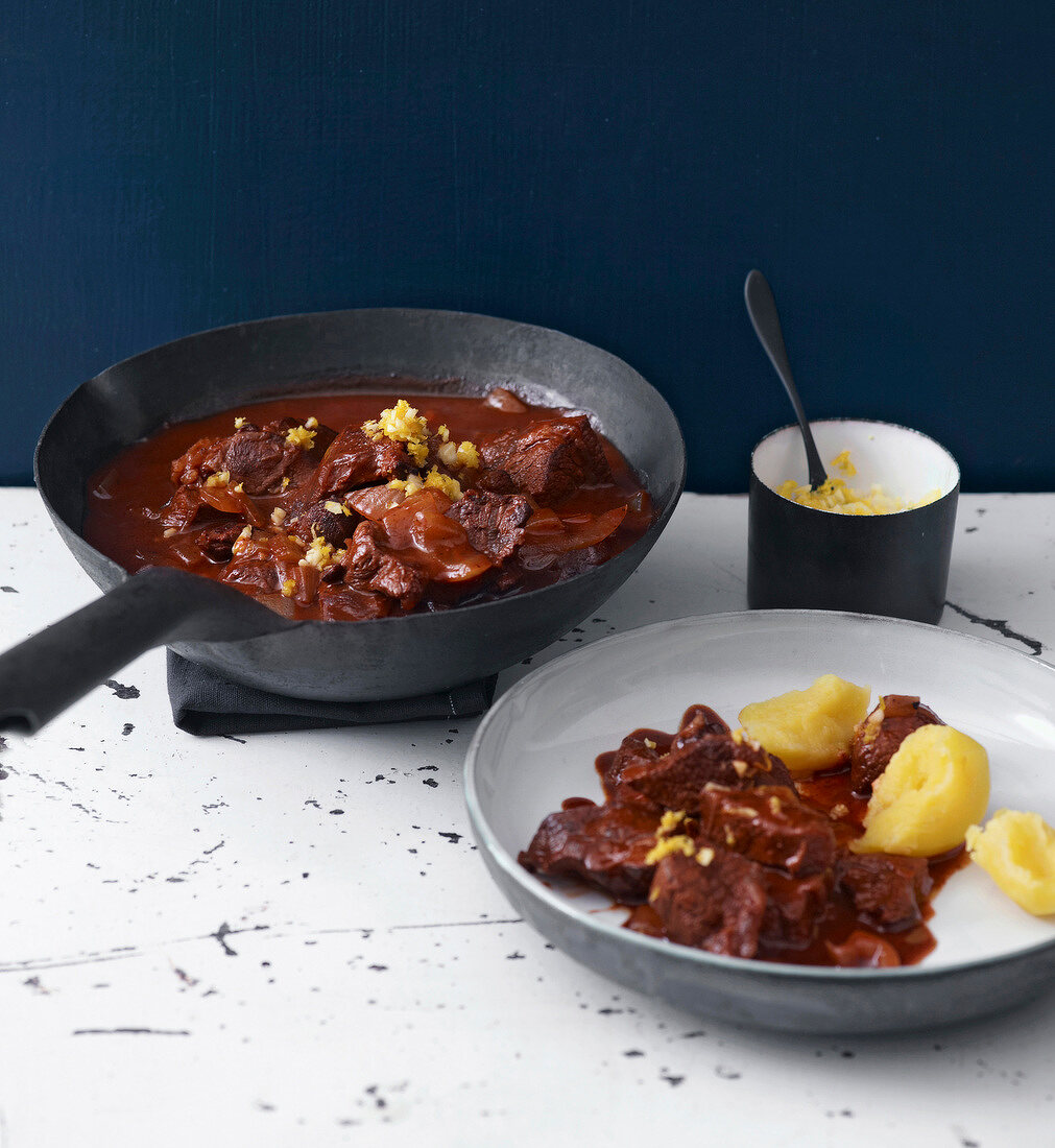 Beef stew with garlic and lemon on plate