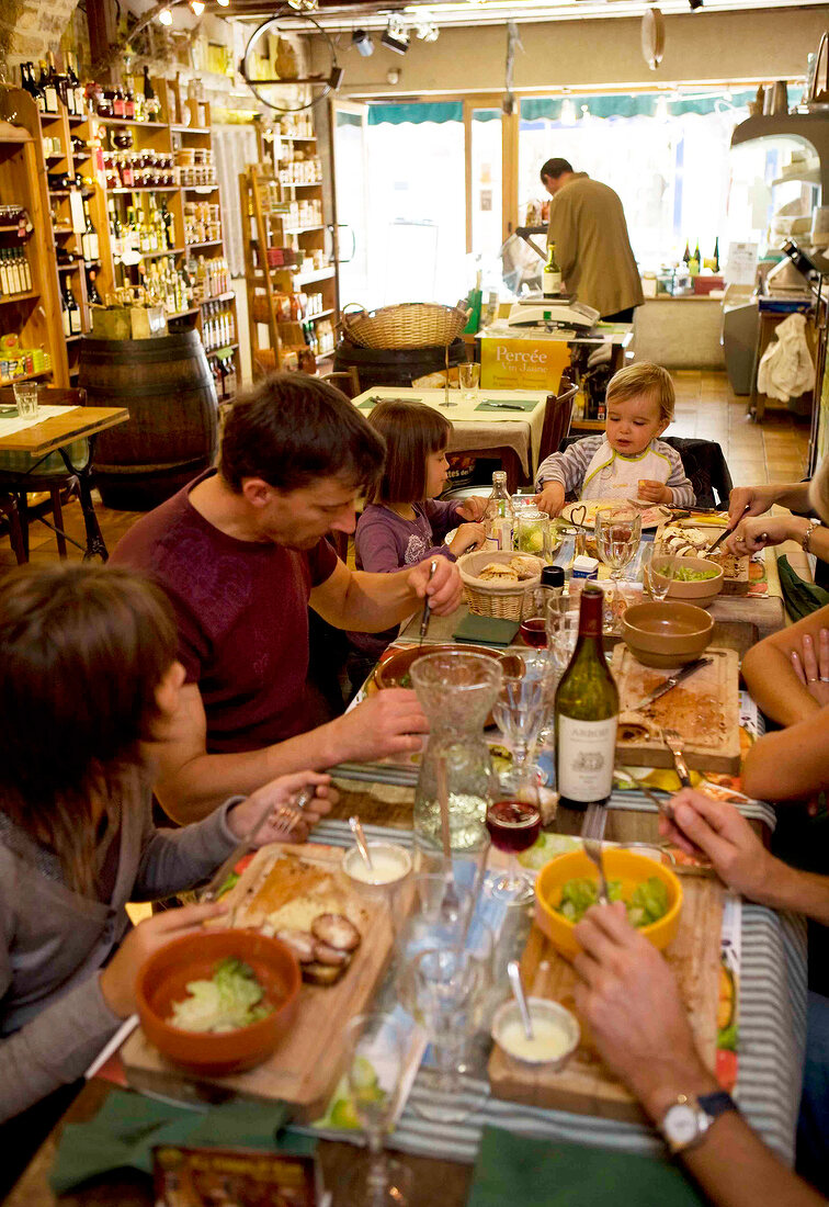 Family having food in Restaurant Les 4 heures du cremier in Arbois, Franche-Comte, France