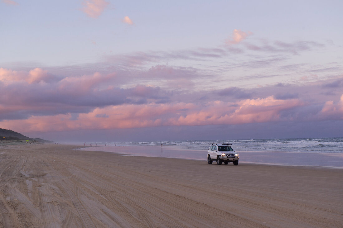 View of sunset with sky, clouds and car, Fraser Island, Queensland, Australia