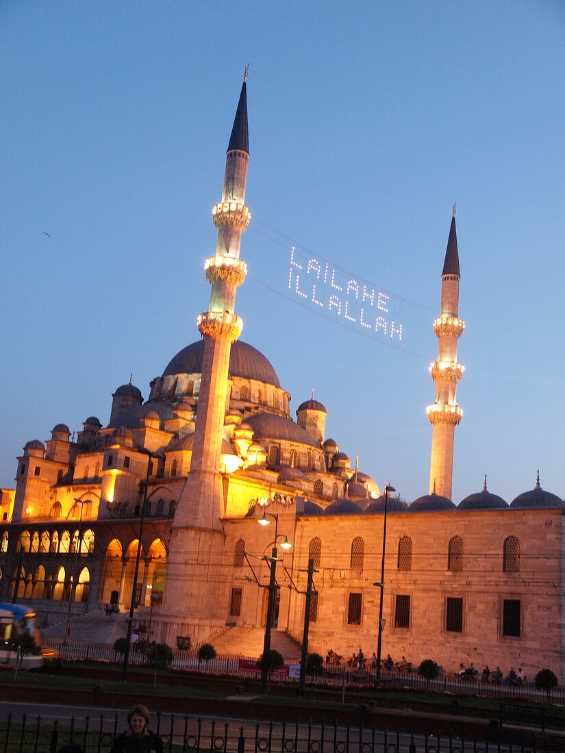 Illuminated Yeni Mosque at dusk in Istanbul, Turkey