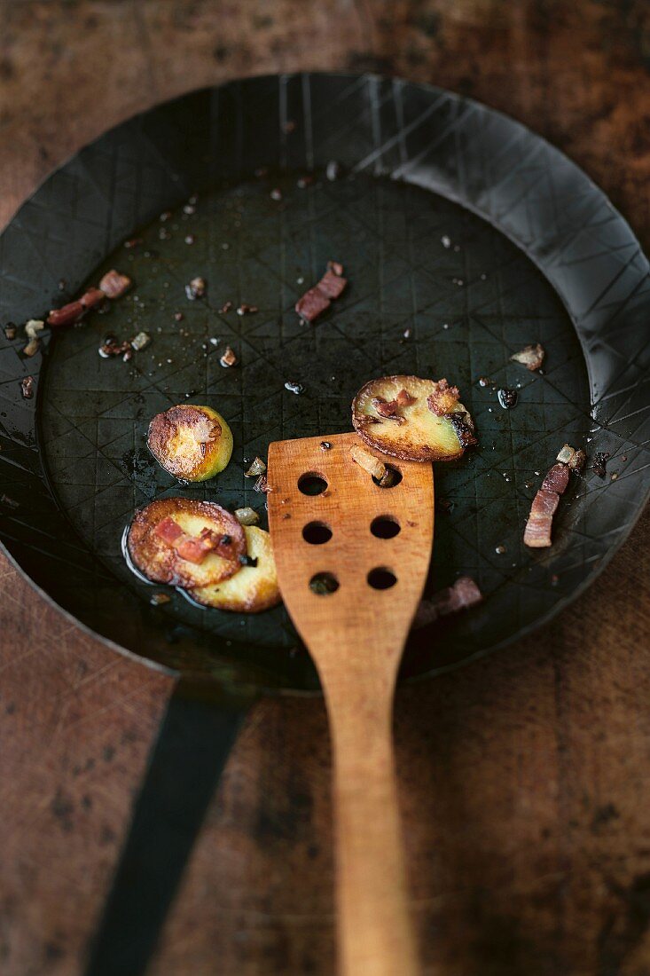 Remains of fried potatoes in a frying pan