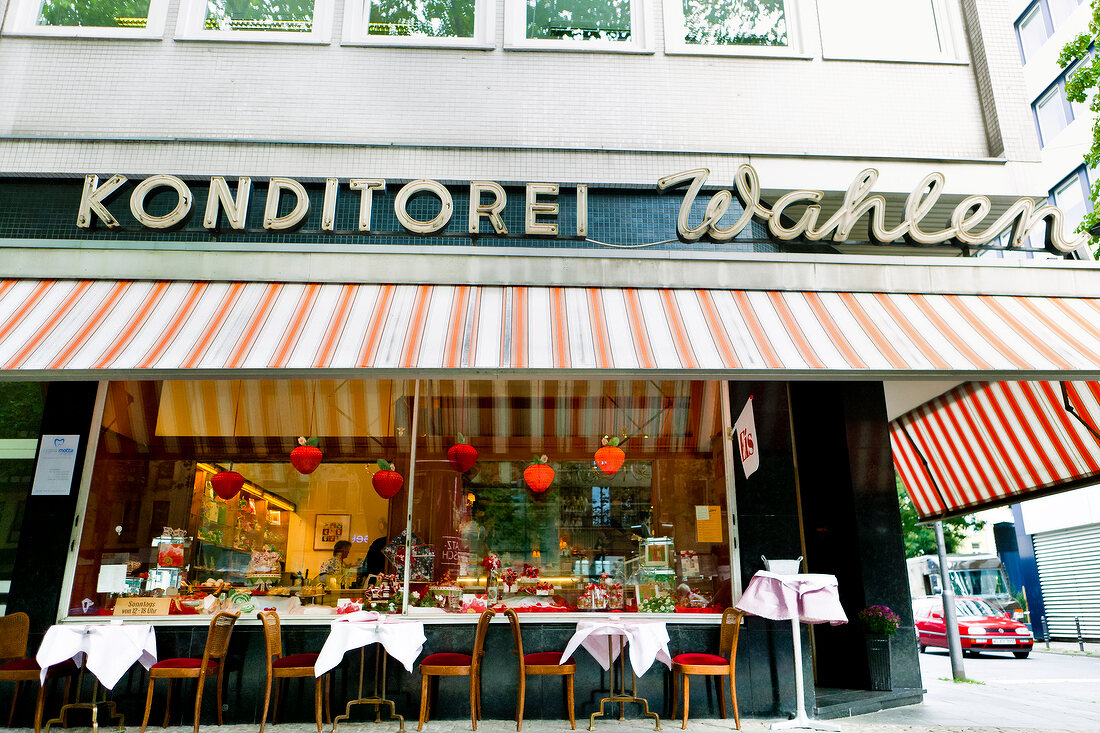 Collection of Pastry in stall with tables and chairs