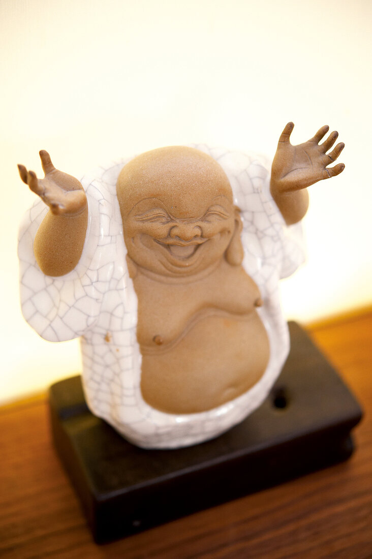 Close-up of Asian Chinese Buddha Figure on table