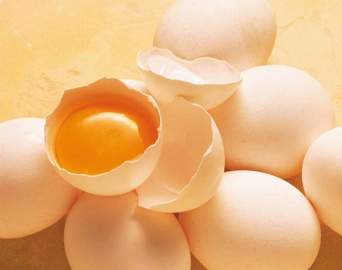 Close-up of raw egg with broken shell and eggs