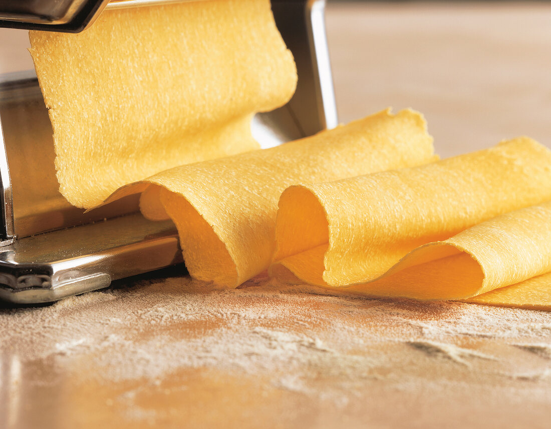 Close-up of pasta dough being rolled out