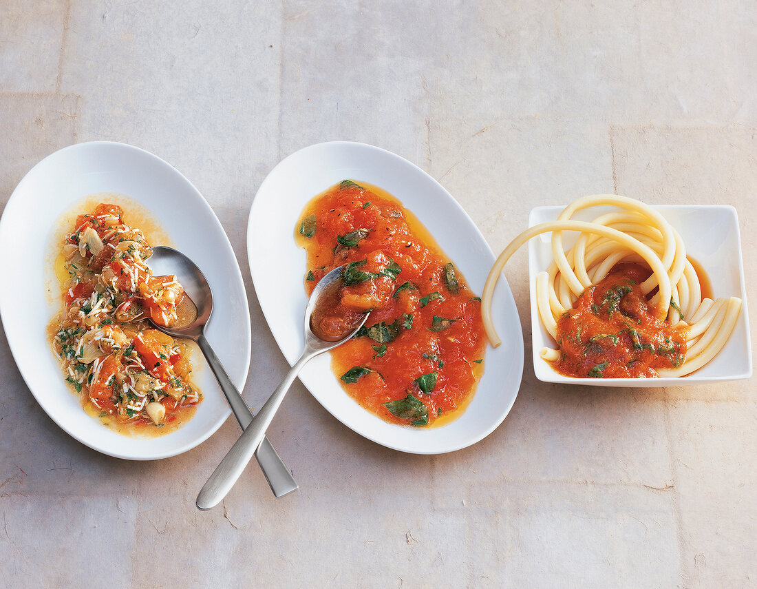 Three different pasta sauces on plates