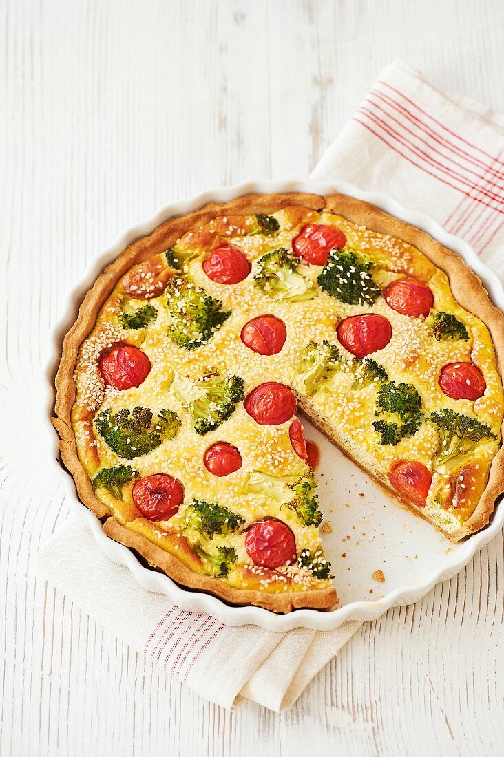 Vegetable flan with broccoli, cherry tomatoes and sesame seeds