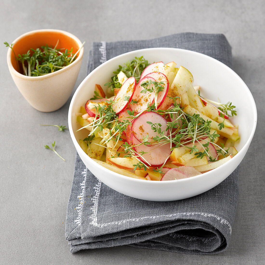 Radish apple with herbs in bowl