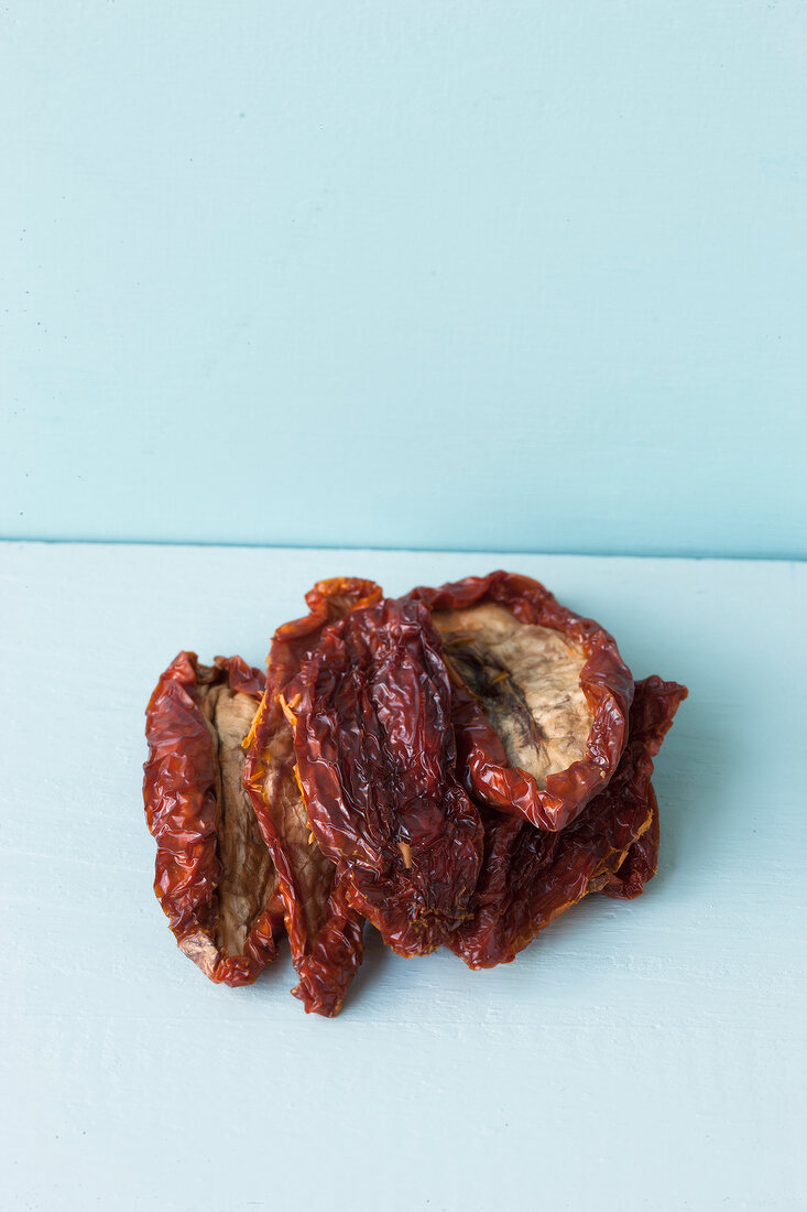 Close-up of dried tomatoes on blue background