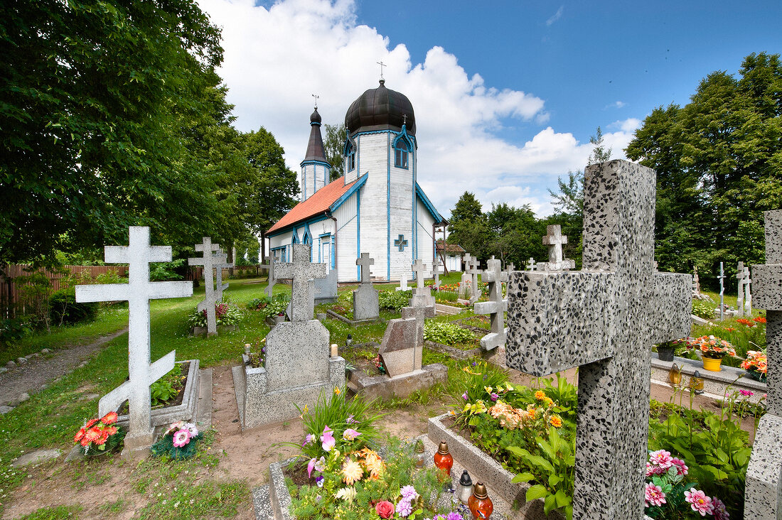 Graves in front of Wojnowo Church in Mikolajki, Warmia-Masuria, Poland