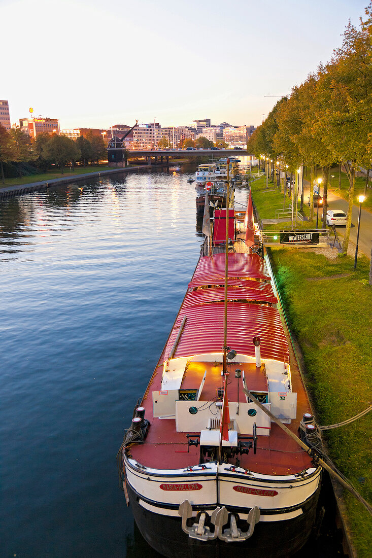 View of theatre ship in river Saar with Berliner Promenade, Saarbrucken, Saarland, Germany