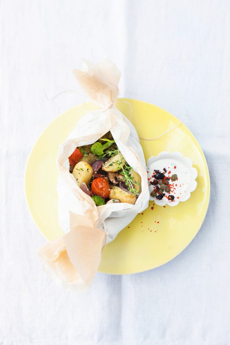 Summer vegetables in parchment paper with a dip