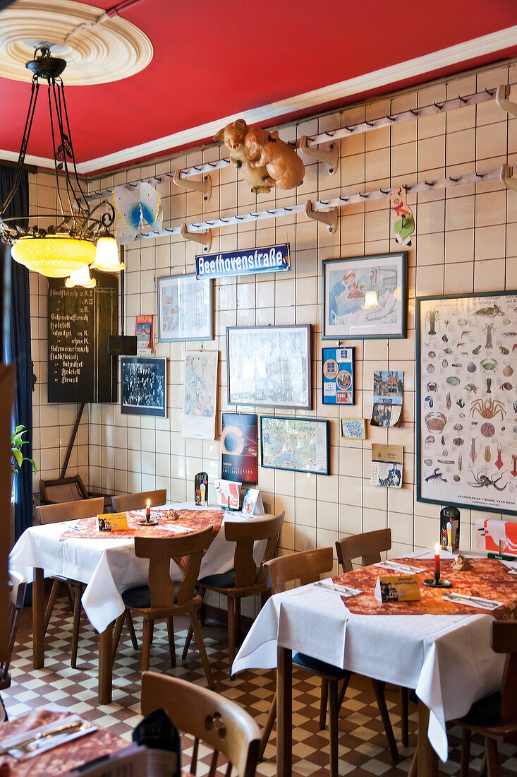 Tables and picture frames on wall of Restaurant Zum Ochsen, St Wendel, Saarland