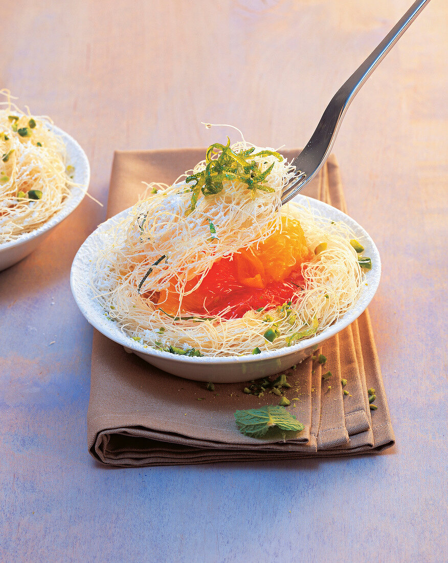 Turkish capellini pasta with citrus fruits in bowl