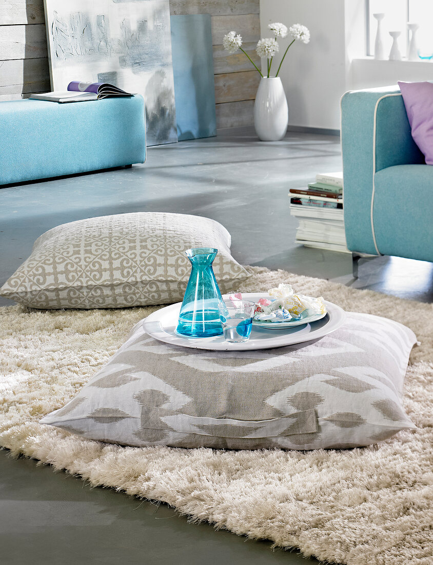Linen floor cushion with handle on beige carpet