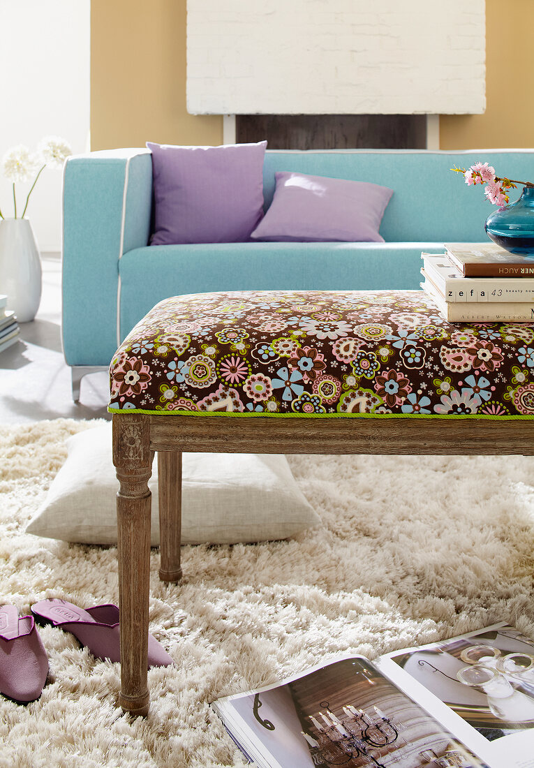 Upholstered bench in the Louis XVI style with patterned fabric coating on beige carpet