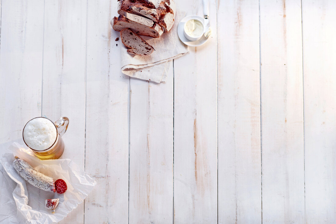 Bavarian bread with glass of beer on wooden background