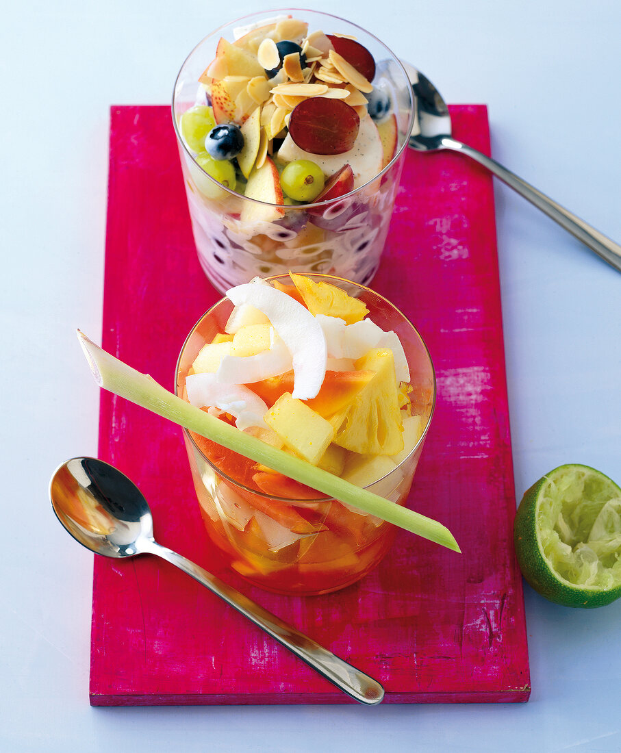 Lime fruit salad and vanilla yogurt fruit salad in glasses