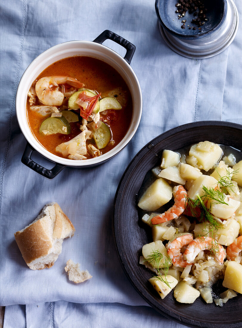 Fennel potato stew with prawns on plate and fish stew in casserole