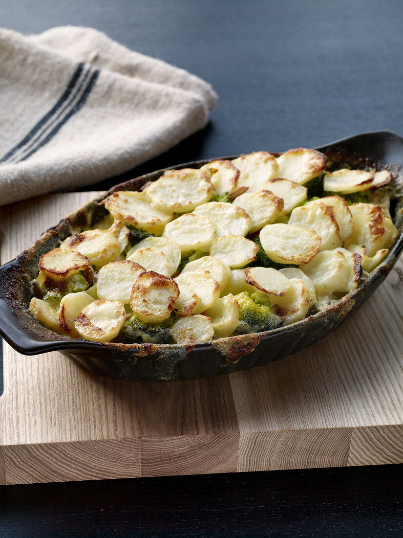 Potato gratin with broccoli in baking dish