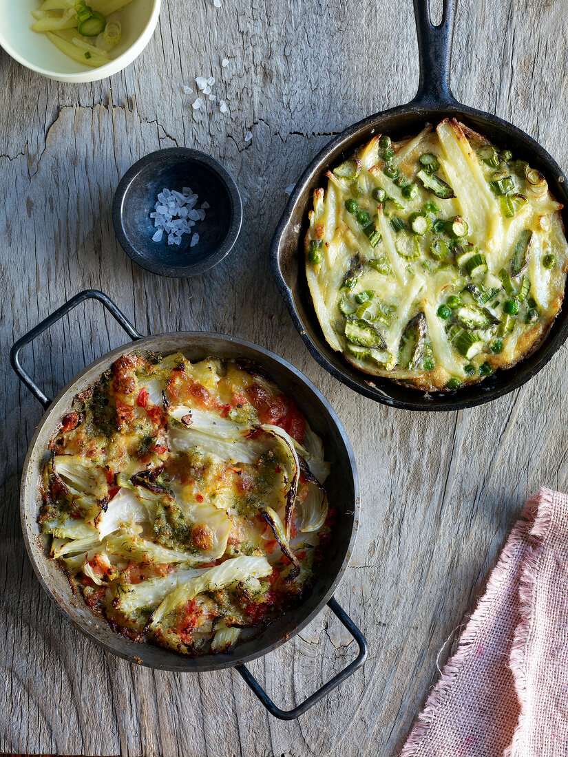 Fennel gratin in pot and vegetable tortilla in wok