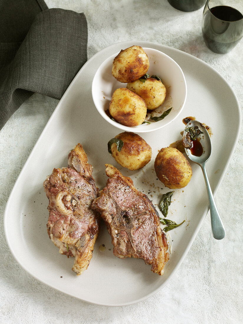 Lamb chops with balsamic potatoes in serving dish