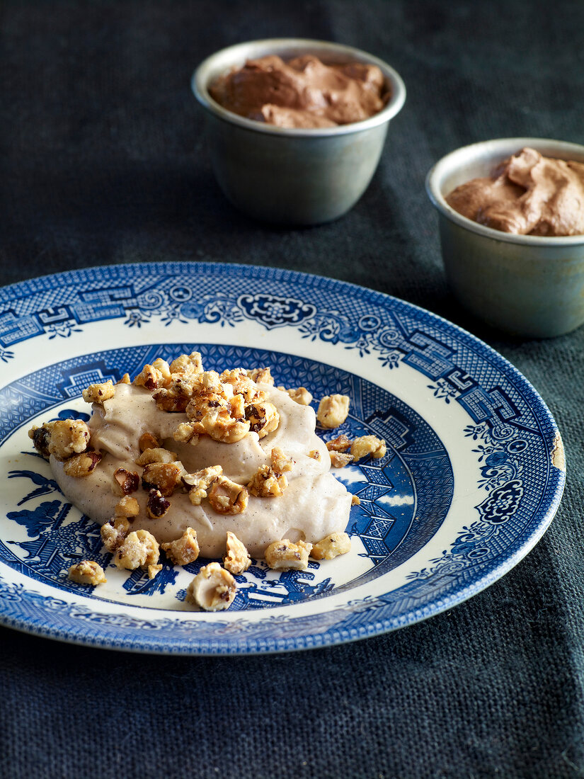 Close-up of chocolate mousse with chestnut cream and hazelnuts on plate