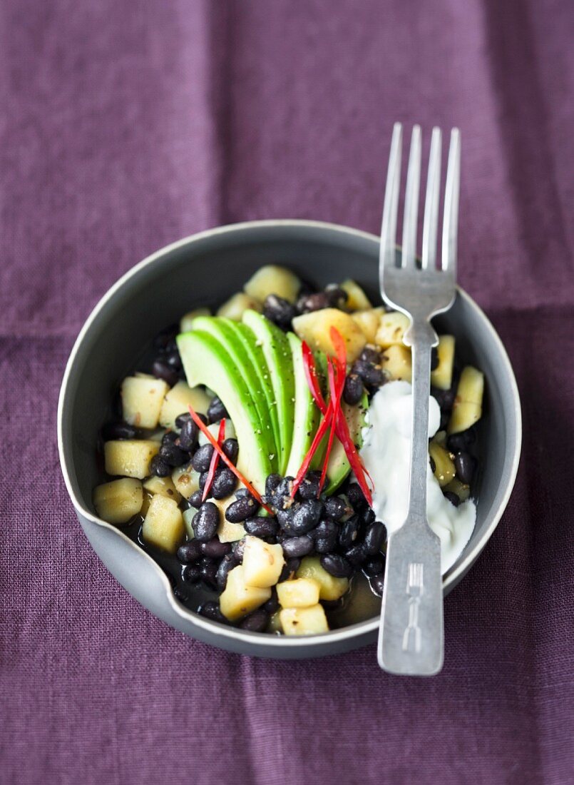 A bean medley with black beans, potatoes and avocado