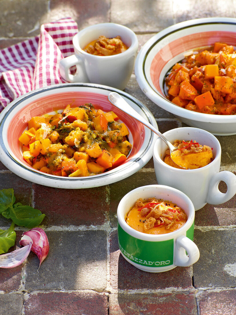 Pumpkin flan with amaretti and pumpkin pesto in bowl during summer, Italy
