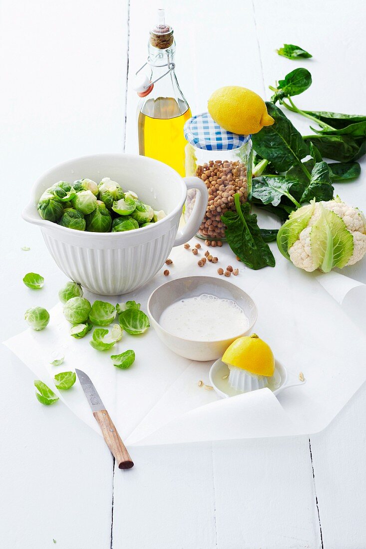 An arrangement of groceries featuring vegetables, legumes and oil