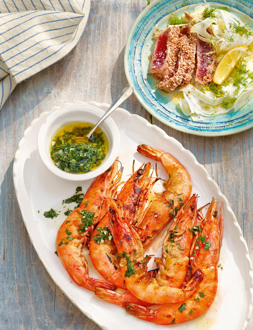 Shrimp and tuna with fennel salad on serving dish during summer, Italy