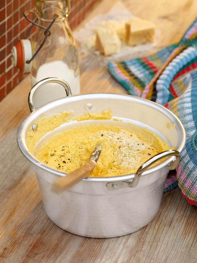 Polenta with butter, cream and parmesan in pot