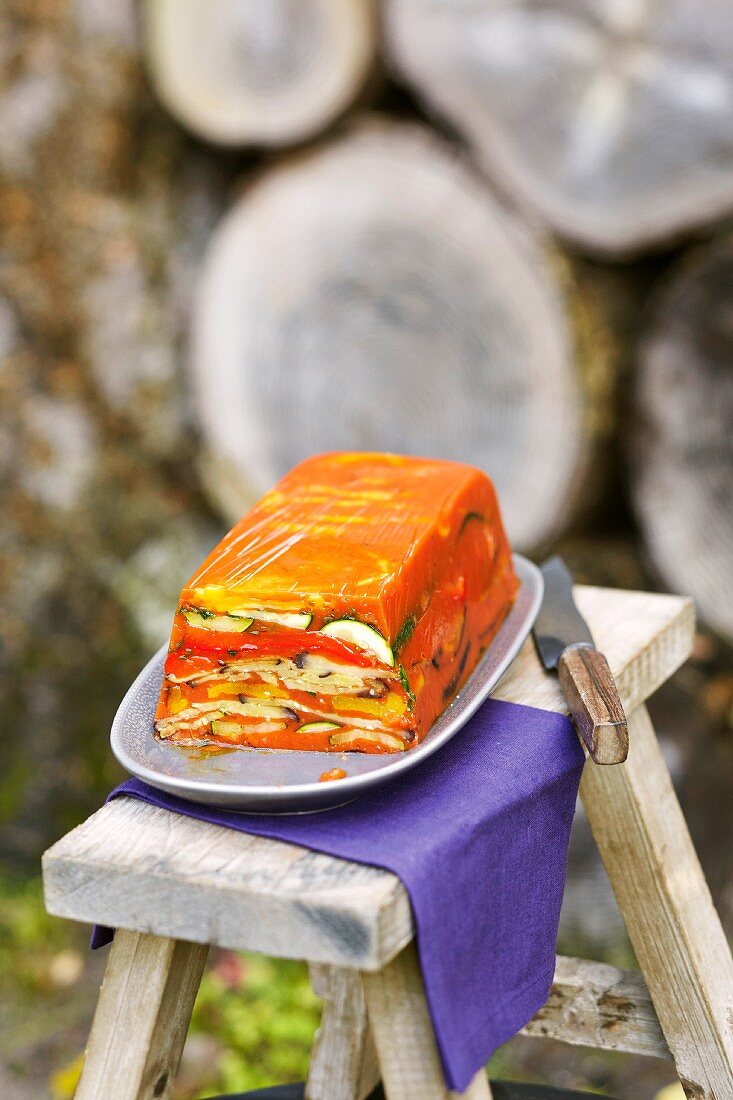 Ratatouille in aspic on a stool outside