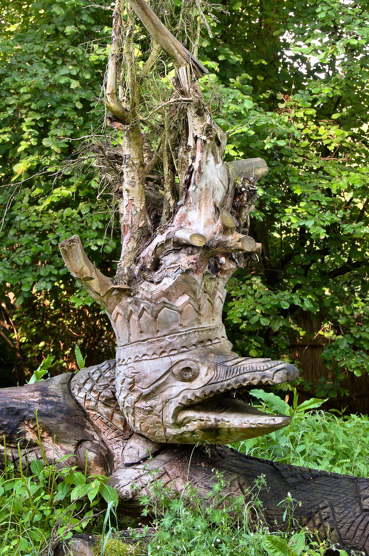 Wooden sculpture amongst trees in Galindia Mazurski Eden, Warmia Masuria, Poland