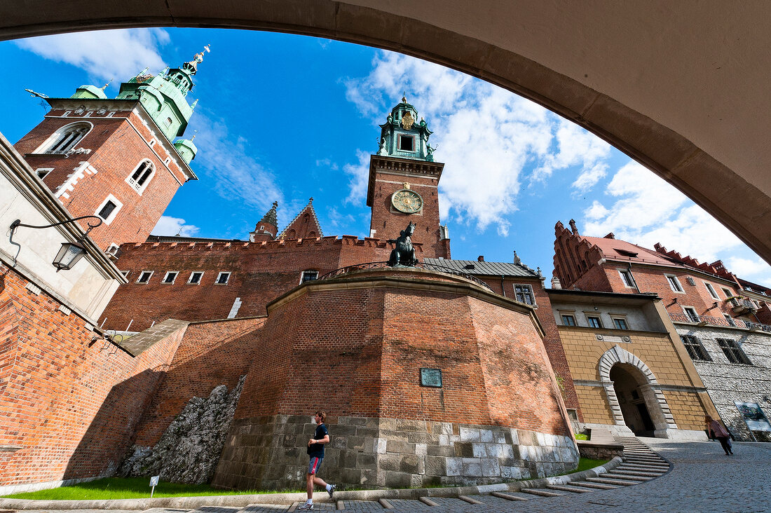 Low angle view of Wawel Royal Castle through arch, Krakow, Poland