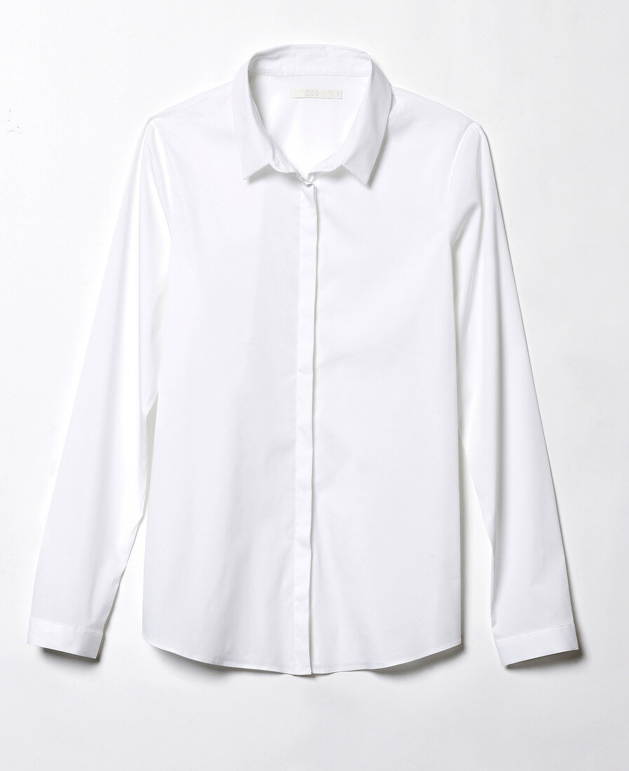 Close-up of plain white shirt blouse on white background