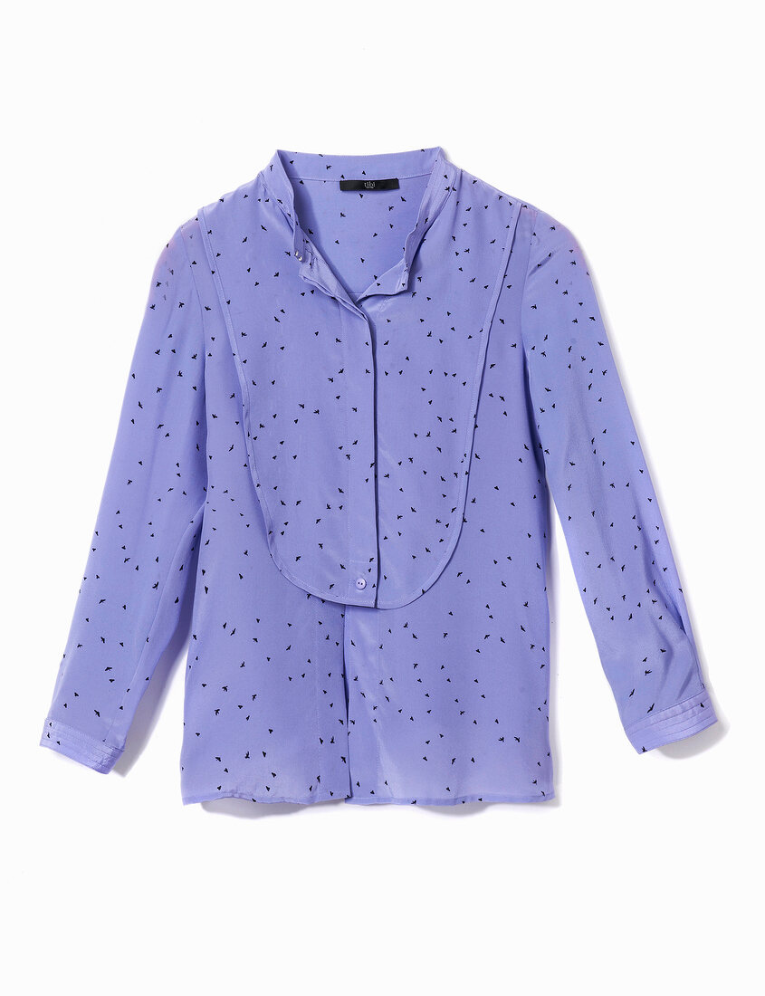 Close-up of violet polka dot shirt blouse on white background