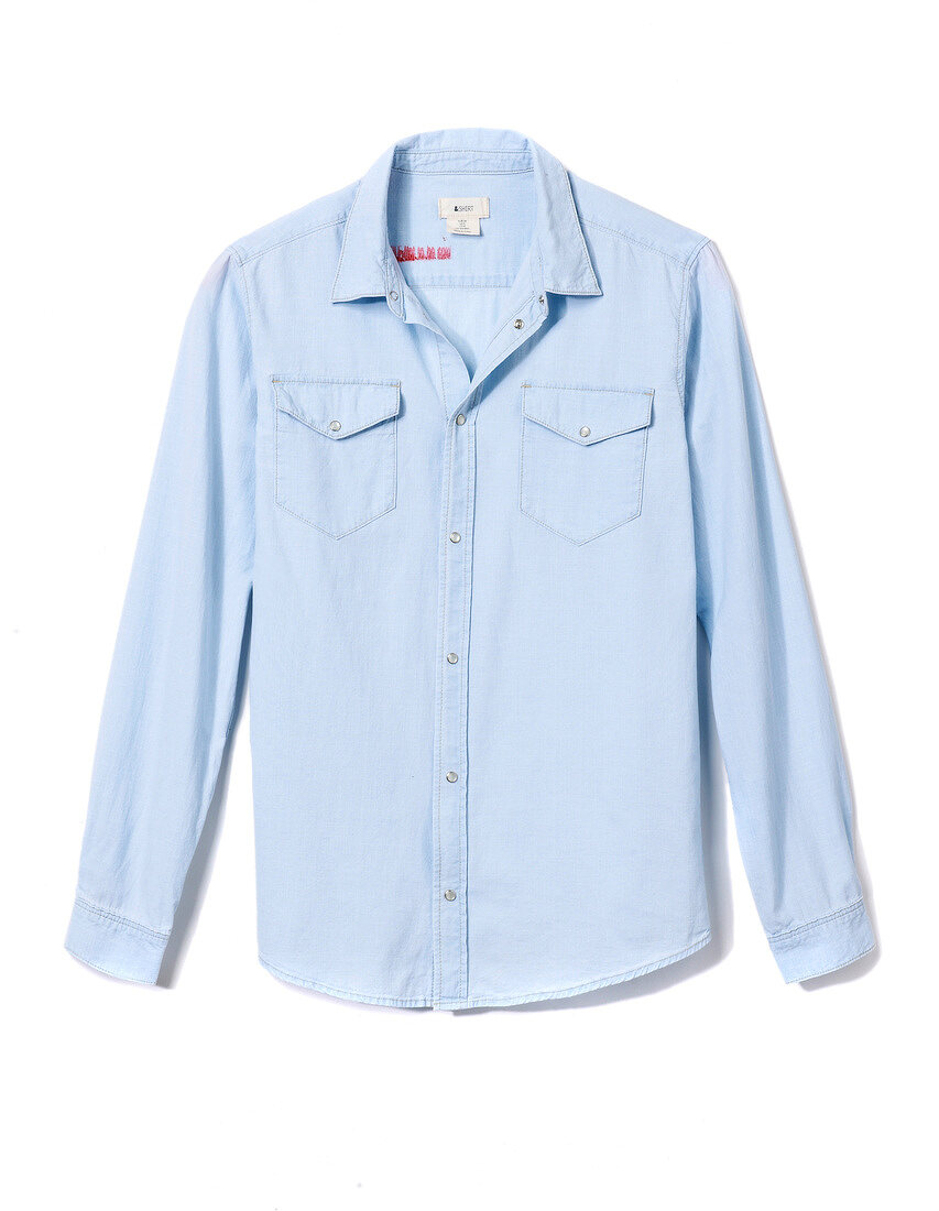 Close-up of blue shirt blouse with basic chest pocket on white background